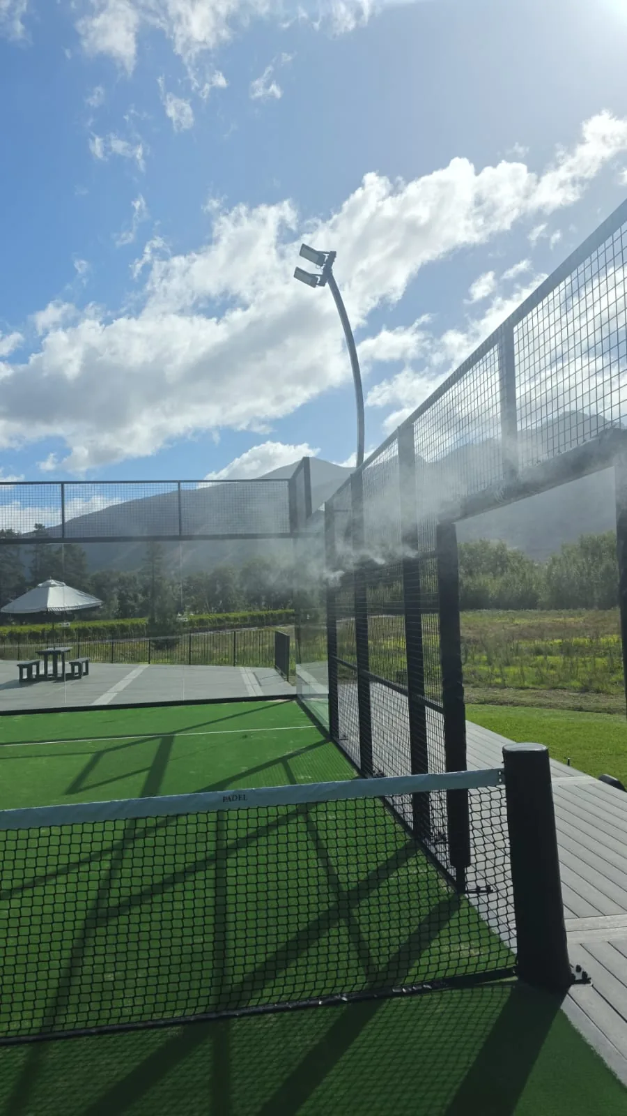 High-pressure misting system in action cooling an outdoor padel court in South Africa